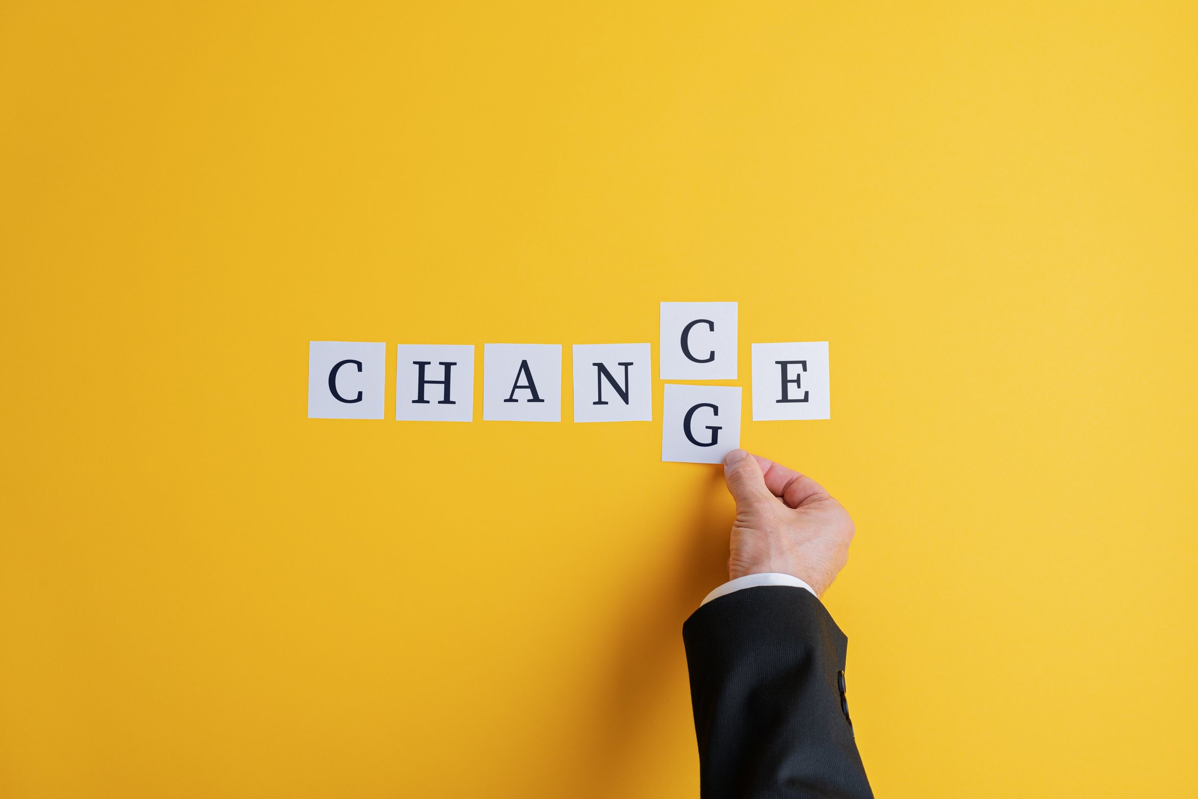 Hand of a Businessman Changing the Word Chance into Change